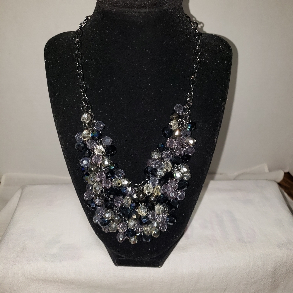 Vintage black necklace with a bib of iridescent beads